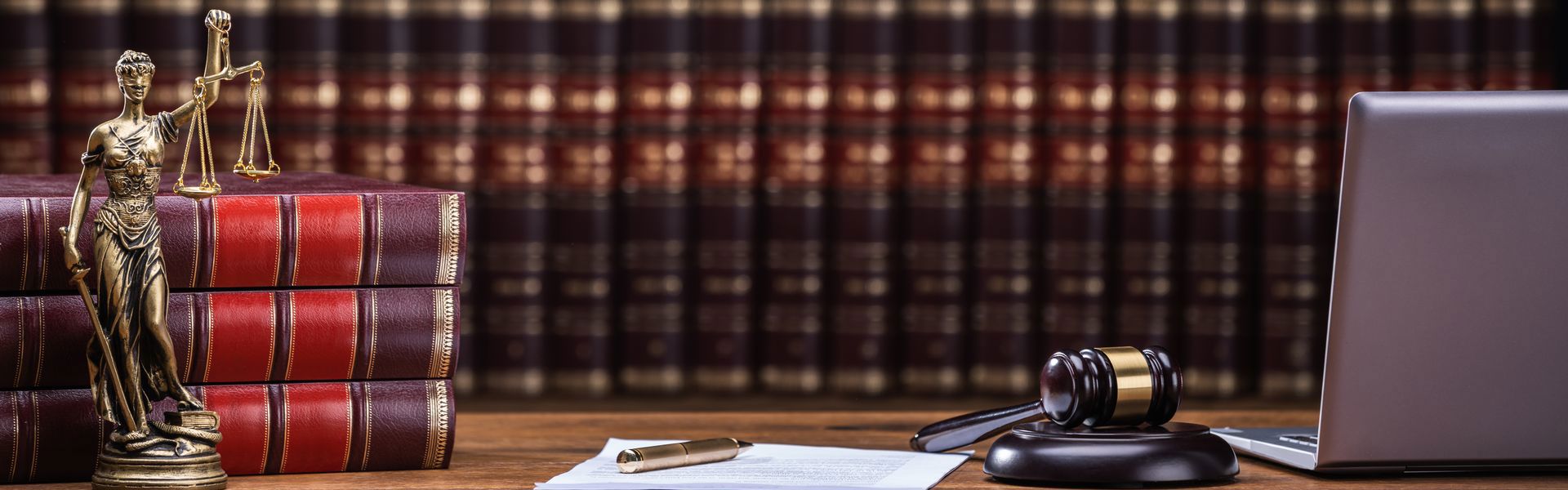 Scales of justice, law books, and a gavel on a table
